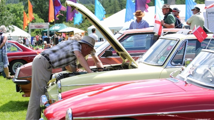 Boundless member inspecting a classic car at a car rally
